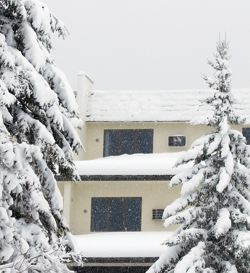 An image of heavy snowfall and snow piling up in early December on buildings in the Village area of Bolton Valley Ski Resort in Vermont