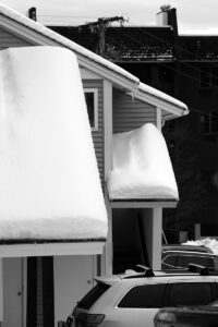 An image of roofs piled up with snow in early December in the Village area of Bolton Valley Ski Resort in Vermont