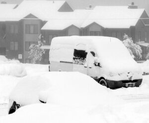 An image of snow-covered vehicles in the main Village parking lots during an early December snowstorm at Bolton Valley Ski Resort in Vermont