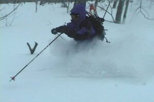 An image of Jay skiing in powder snow in February during a backcountry ski tour of Gilpin Mountain near Jay Peak Resort in Vermont