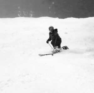 A black and white image of Jay Telemark skiing on the Hard Luck trail during the Christmas holiday week at Bolton Valley Resort in Vermont