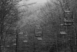 An image of the Wilderness Double Chairlift with light accumulations of snow from a recent small weather system at Bolton Valley Ski Resort in Vermont