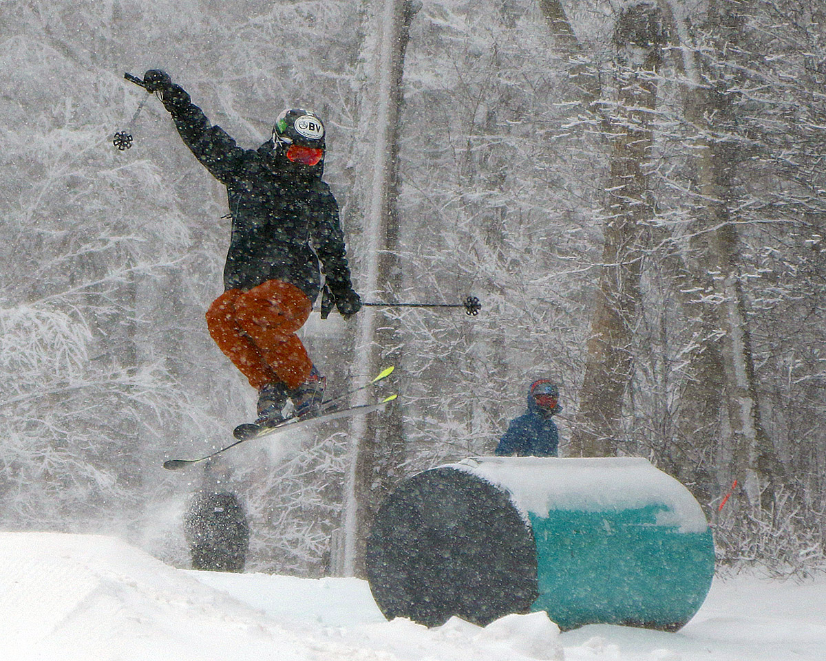An image of Ty catching some air in the Hide Away terrain park area during the beginning of Winter Storm Ember at Bolton Valley Resort in Vermont