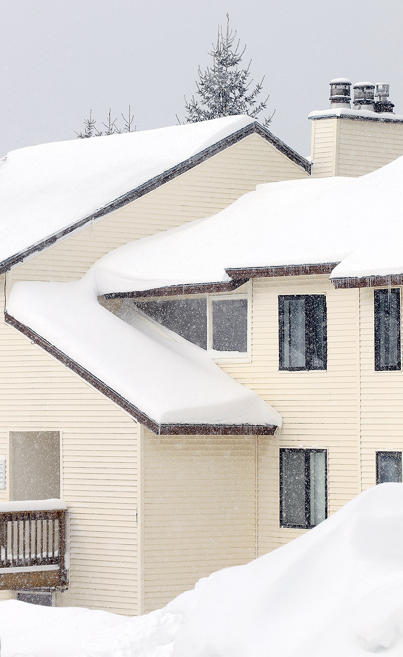 An image of some condominiums with snow on the roof and more snow falling as moisture from Lake Ontario helps to reinvigorate snowfall up at Bolton Valley Ski Resort in Vermont