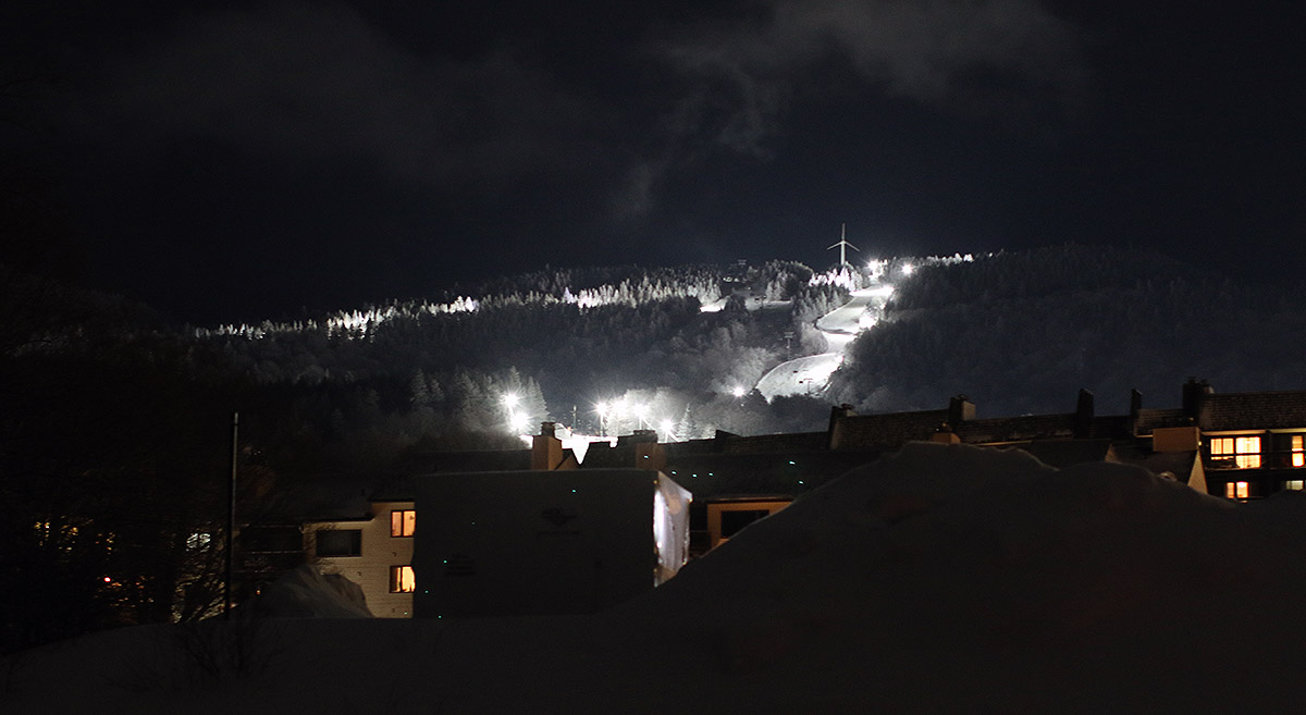 A view of some of the night skiing terrain and part of the Village from down in the lower parking lots during a night skiing session at Bolton Valley Ski Resort in Vermont