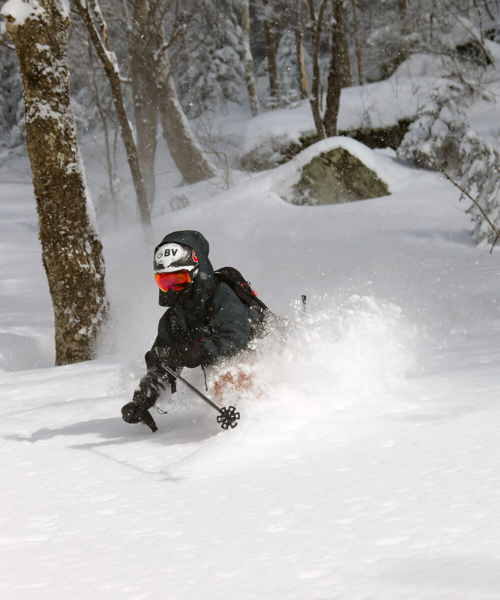 An image of Ty skiing in deep champagne powder from a February snowstorm in the Moose Glen area of the Nordic and Backcountry Network of Bolton Valley Ski Resort in Vermont