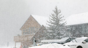 An image of the Timberline Base Lodge through heavy snowfall from a February snowstorm at Bolton Valley Ski Resort in Vermont
