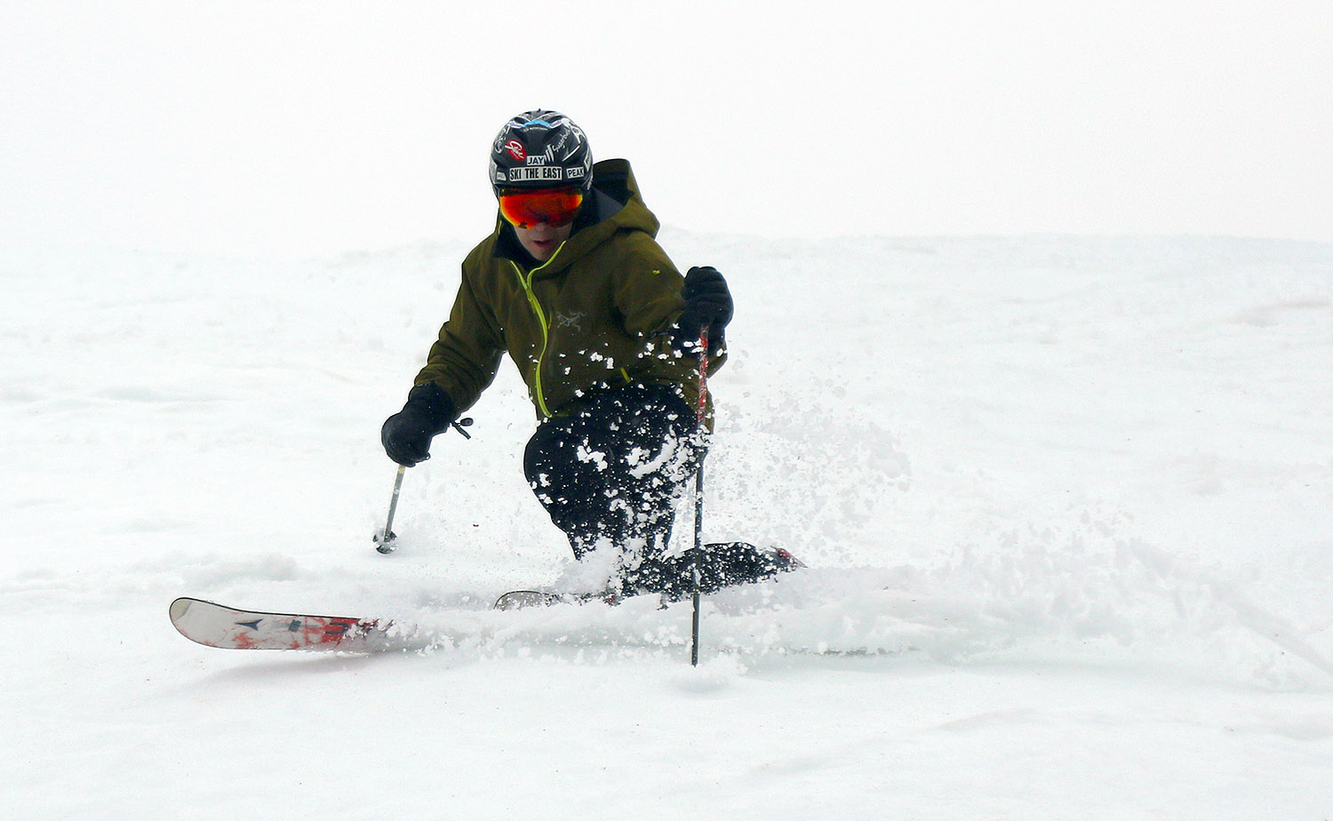 An image of Jay making a Telemark turn in some early spring snow in the Timberline area at Bolton Valley Ski Resort in Vermont