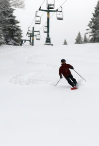 An image of Dylan adding the first ski track below the Wilderness Lift in some March powder from a late winter storm at Bolton Valley Ski Resort in Vermont