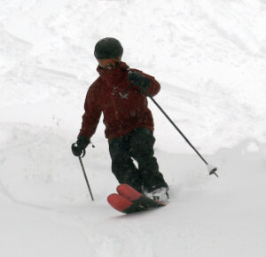 An image of Dylan surfing in some of the plentiful March powder from a late winter storm at Bolton Valley Ski Resort in Vermont