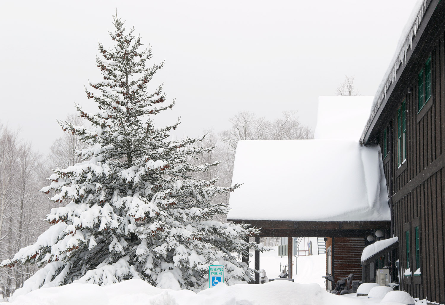 An image of the Timberline Base Lodge area covered in plentiful fresh powder from ongoing Winter Storm Tormund in April of 2024 at Bolton Valley Ski Resort in Vermont