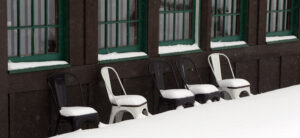 An image of chairs outside the Timberline Base Lodge adorned with a bit of snow from ongoing Winter Storm Tormund in April 2024 at Bolton Valley Ski Resort in Vermont