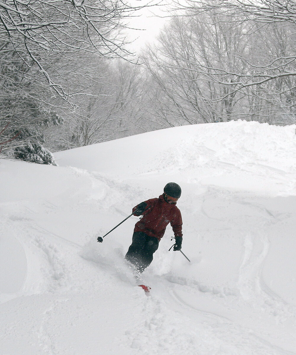An image of Dylan adding a ski track on the Vermont 200 trail in some March powder from a late winter storm at Bolton Valley Ski Resort in Vermont