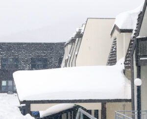 An image of the Bolton Valley Hotel in the Bolton Valley Village with plentiful snow on accumulations from Winter Storm Tormund in April 2024 at Bolton Valley Ski Resort in Vermont