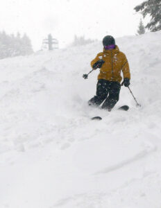 An image of Jack reaching for his next turn as he skis fresh snow during Winter Storm Tormund in April 2024 at Bolton Valley Ski resort in Vermont