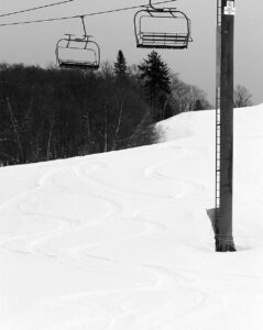 An image of the Valley Road area with powder ski tracks in additional snow that had fallen after grooming during a mid-March snowstorm at Bolton Valley Ski Resort in Vermont