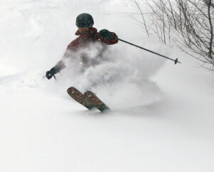 An image of Dylan blasting through fresh powder snow during Winter Storm Ronnie at Bolton Valley Ski Resort in Vermont