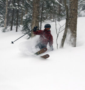 An image of Dylan surfing through some fresh powder while skiing the trees during Winter Storm Ronnie at Bolton Valley Ski Resort in Vermont