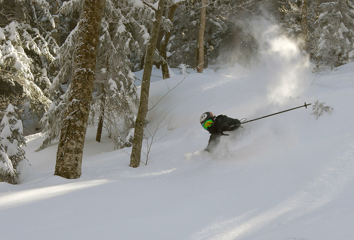 An image of Ty blasting through waist to chest deep powder on the day after Winter Storm Ronnie at Bolton Valley Ski Resort in Vermont