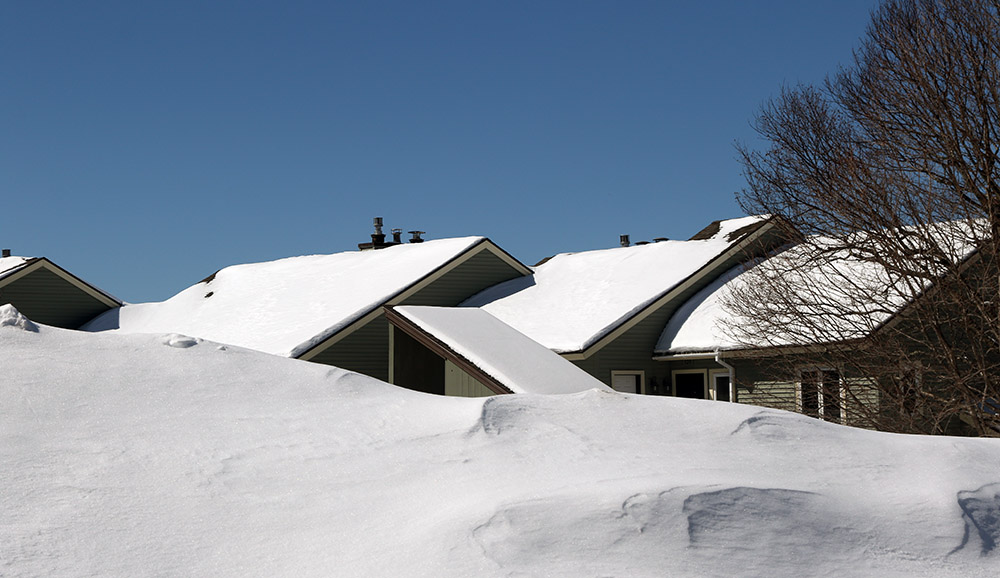 An image of large snowbanks and snow on houses from recent Winter Storm Ronnie in the Village area at Bolton Valley Ski Resort in Vermont