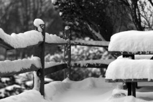 An image of snow on tables and railings during early December in the Village area at Bolton Valley Ski Resort in Vermont