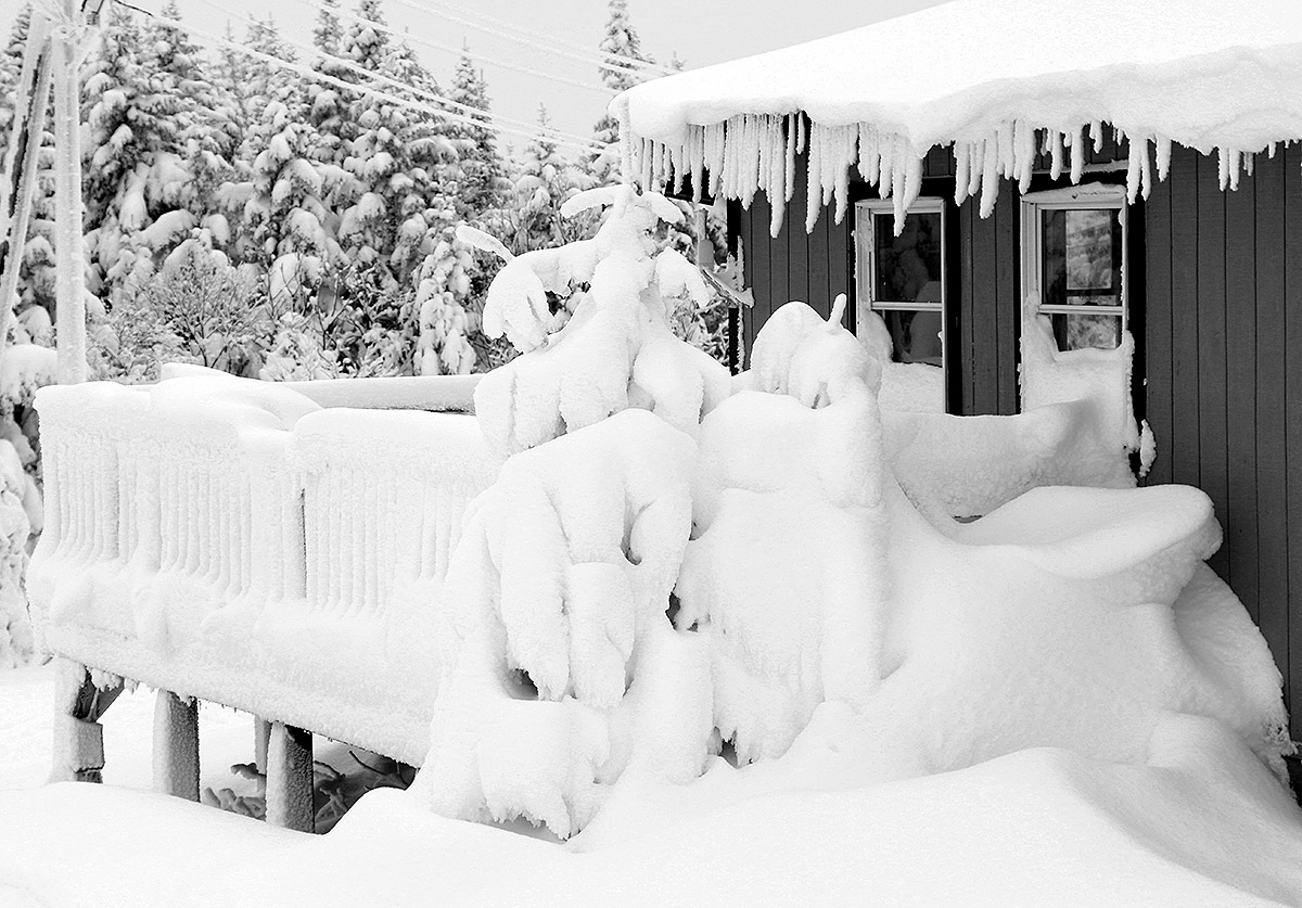 An image showing a heavy coating of snow on the Ski Patrol Station at the top of the Vista Quad Chairlift at Bolton Valley Ski Resort in Vermont