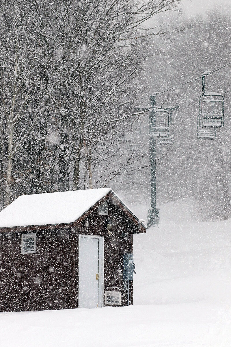 An image of heavy snowfall hitting the base of the Wilderness Double Chairlift in mid-December at Bolton Valley Ski Resort in Vermont