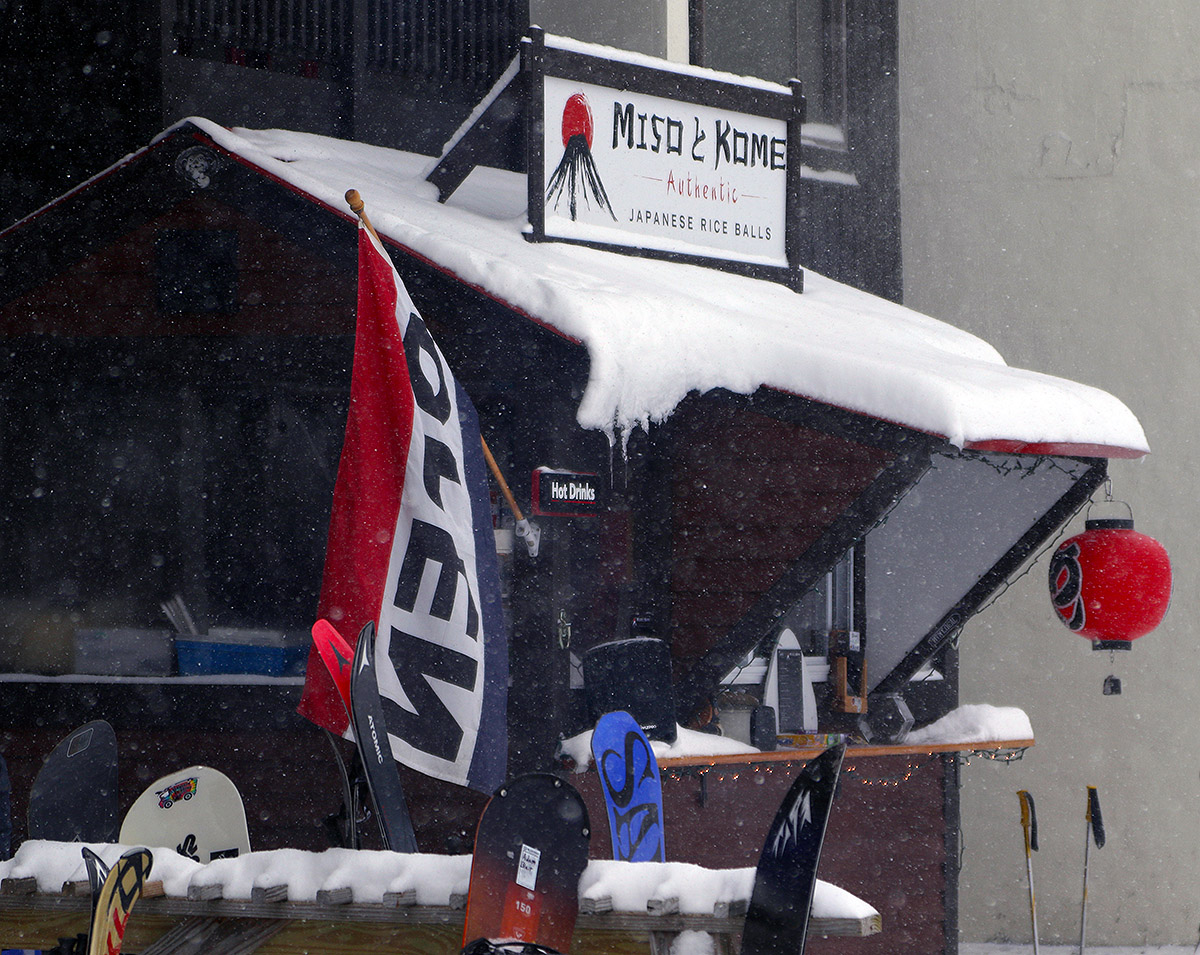 An image of the Miso Kome Japanese rice balls stand with light snowfall at the main base area of Bolton Valley Ski Resort in Vermont