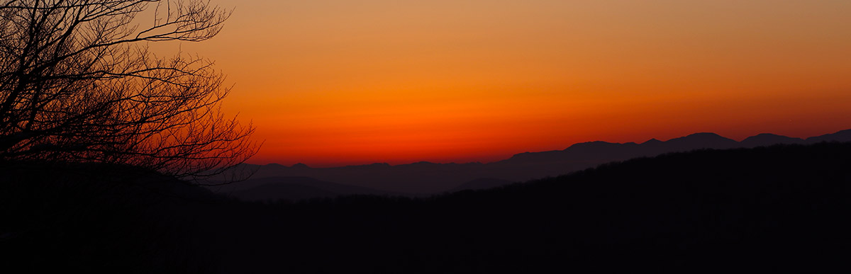 An image of a December sunset viewed from the slopes of the Timberline area while ski touring at Bolton Valley Ski Resort in Vermont