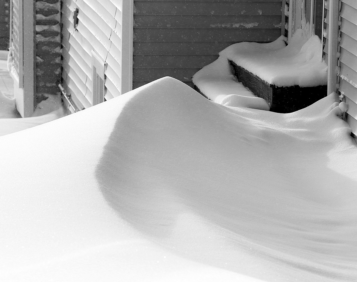 An image of a snowdrift outside the condominiums near the base of the Wilderness Double Chairlift during a January snowstorm at Bolton Valley Ski Resort in Vermont