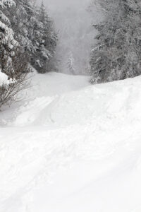 An image looking down the Vermont 200 ski trail during a long-duration winter storm in January at Bolton Valley Ski Resort in Vermont