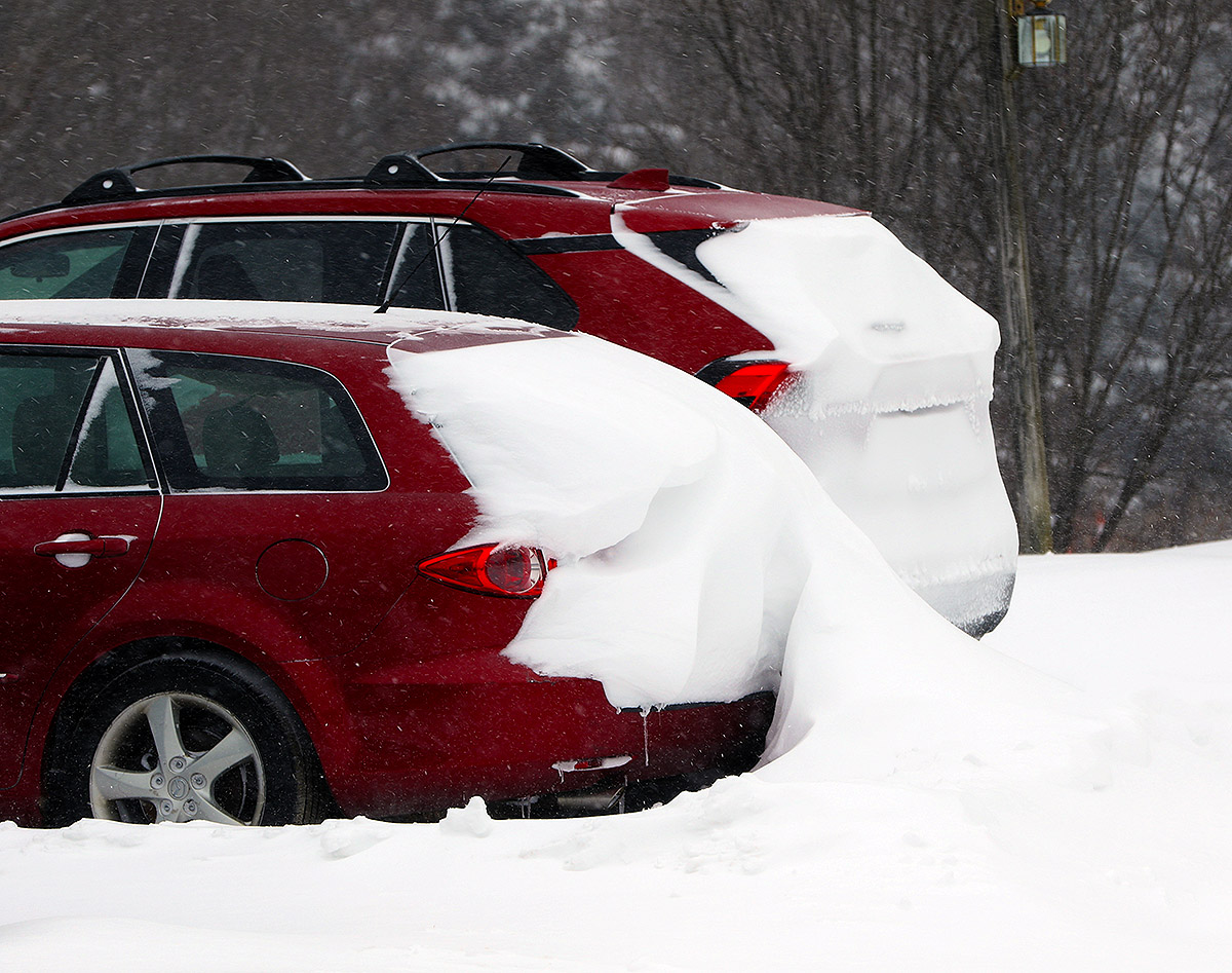 An image of cars with interesting formations of drifted snow in January during a long-duration winter storm in the Village area of Bolton Valley Ski Resort in Vermont