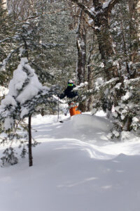 An image of Ty beginning the descent of a line in the Wilderness Woods area on Telemark skis during a January ski outing at Bolton Valley Ski Resort in Vermont