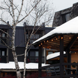 An image of the gazebo and hotel with snow by the Village Circle during the holidays at Bolton Valley Ski Resort in Vermont